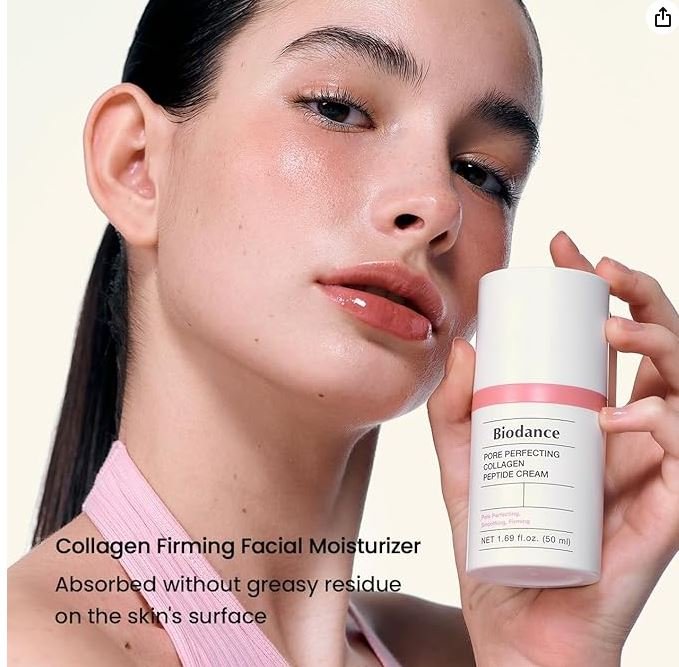 A model with radiant, glowing skin holding a bottle of Biodance Pore Perfecting Collagen Peptide Cream. The product is a white and pink pump bottle. Next to the model, the text reads: "Collagen Firming Facial Moisturizer - Absorbed without greasy residue on the skin's surface."